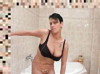 Short haired brunette with huge saggers pisses and takes a shower