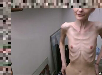 Skinny brunette posing topless
