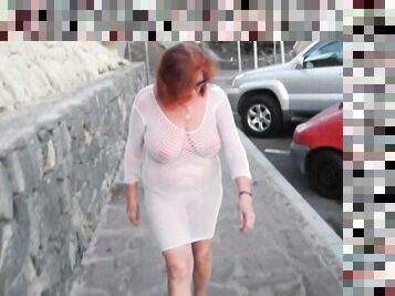 Mature in a transparent net walks down the street
