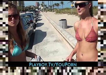A pair of bikini babes get paid cash on the beach